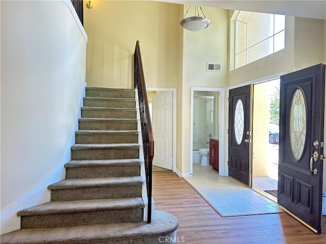 606 W Grand Ave, Pomona, CA 91766 - entryway with stairway, wood finished floors, and a high ceiling