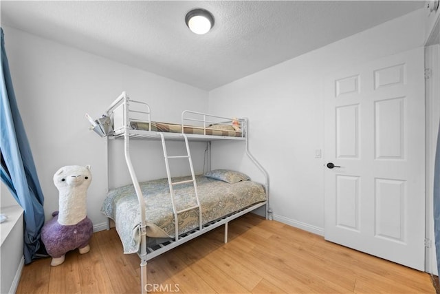 11571 Pinnacle Peak Ct, Rancho Cucamonga, CA 91737 - bedroom with wood finished floors and a textured ceiling