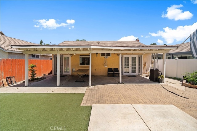 11571 Pinnacle Peak Ct, Rancho Cucamonga, CA 91737 - rear view of property with french doors, a tiled roof, stucco siding, and a fenced backyard