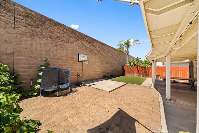 11571 Pinnacle Peak Ct, Rancho Cucamonga, CA 91737 - fenced backyard featuring a trampoline and a patio area