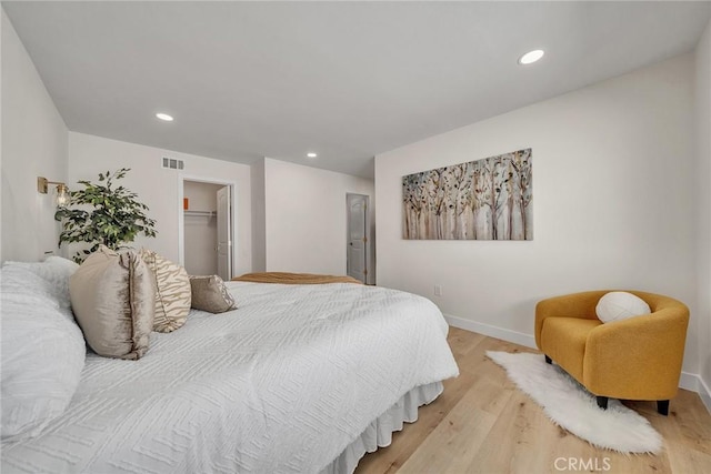 14181 Moore Ct, Irvine, CA 92606 - bedroom with light wood-style flooring, recessed lighting, a walk in closet, and a closet