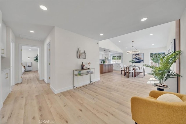 14181 Moore Ct, Irvine, CA 92606 - hallway with light wood-type flooring, recessed lighting, and a chandelier