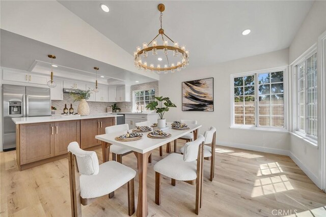 14181 Moore Ct, Irvine, CA 92606 - dining space featuring light wood-style flooring, recessed lighting, a chandelier, vaulted ceiling, and a tray ceiling