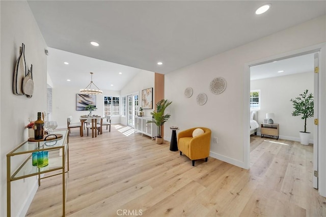 14181 Moore Ct, Irvine, CA 92606 - sitting room with plenty of natural light, light wood-style floors, vaulted ceiling, recessed lighting, and a chandelier