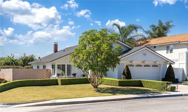 14181 Moore Ct, Irvine, CA 92606 - view of front of property featuring a garage, concrete driveway, stucco siding, and a chimney