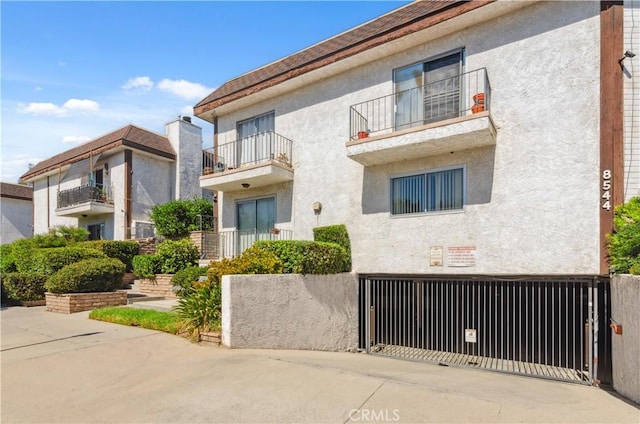 8544 Independence Ave Unit 102, Canoga Park, CA 91304 - view of building exterior featuring an attached garage and concrete driveway