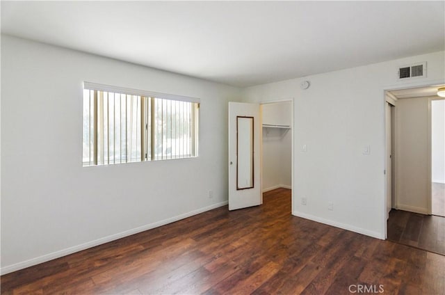 8544 Independence Ave Unit 102, Canoga Park, CA 91304 - unfurnished bedroom with dark wood-style floors, a closet, and a walk in closet
