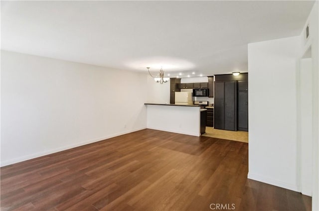 8544 Independence Ave Unit 102, Canoga Park, CA 91304 - unfurnished living room with a chandelier and dark wood finished floors