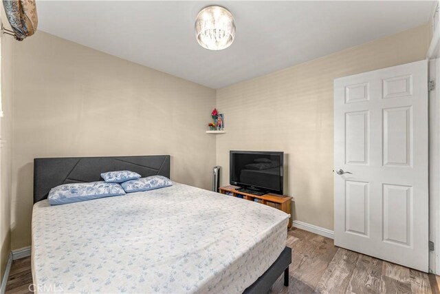 404 Atwood Dr, Corona, CA 92879 - bedroom featuring wood finished floors and baseboards