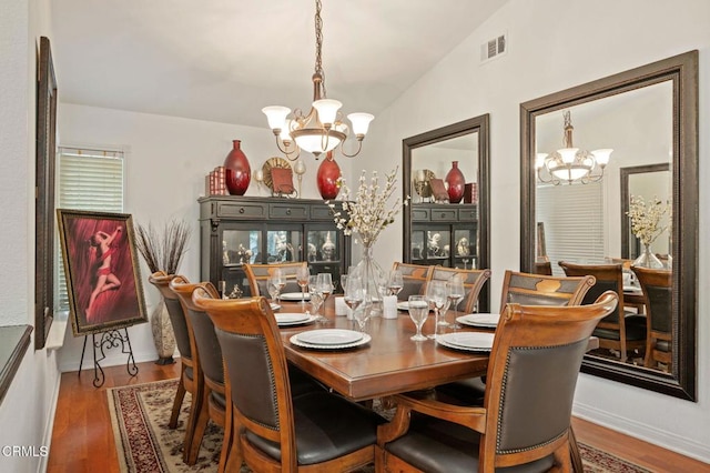 1501 Devonshire Dr, Oxnard, CA 93030 - dining space with a chandelier, vaulted ceiling, and wood finished floors
