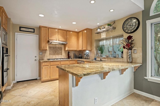 1501 Devonshire Dr, Oxnard, CA 93030 - kitchen featuring a peninsula, tasteful backsplash, a breakfast bar, and recessed lighting