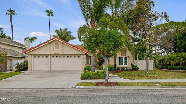 1501 Devonshire Dr, Oxnard, CA 93030 - view of front of home with a garage, driveway, stucco siding, and a tile roof