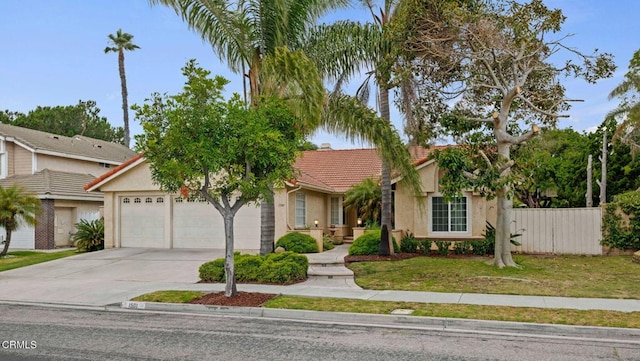 1501 Devonshire Dr, Oxnard, CA 93030 - view of property hidden behind natural elements with a tile roof, an attached garage, concrete driveway, and stucco siding