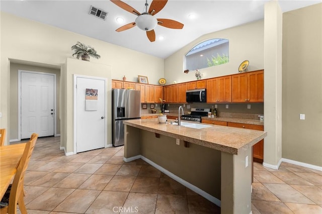 1447 White Cloud Ln, Beaumont, CA 92223 - kitchen featuring appliances with stainless steel finishes, a ceiling fan, light countertops, high vaulted ceiling, and a kitchen island with sink