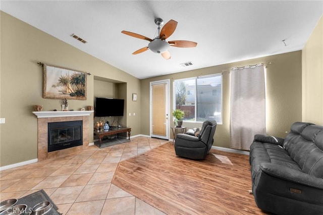 1447 White Cloud Ln, Beaumont, CA 92223 - living room featuring a ceiling fan, lofted ceiling, light tile patterned floors, a fireplace, and built in shelves