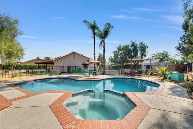12312 Marmont Pl, Moreno Valley, CA 92557 - view of pool with a pool with connected hot tub, a fenced backyard, a patio, and a storage unit