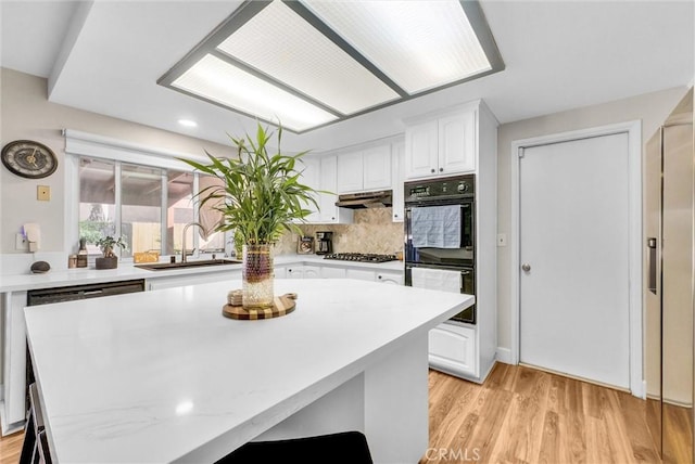12312 Marmont Pl, Moreno Valley, CA 92557 - kitchen featuring white cabinetry, light countertops, stainless steel gas cooktop, light wood-style floors, and recessed lighting
