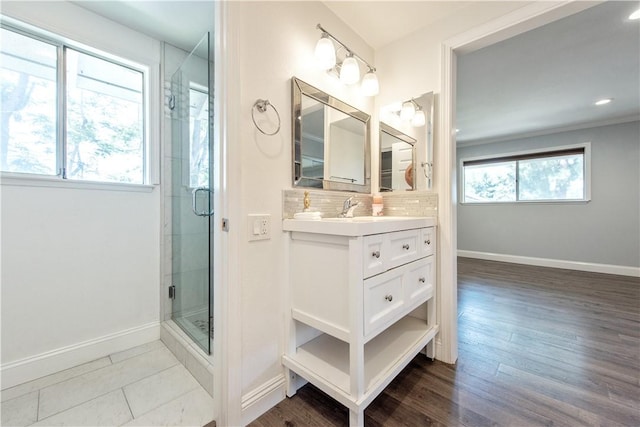 811 Ronda Mendoza Unit P, Laguna Woods, CA 92637 - bathroom featuring vanity, a stall shower, decorative backsplash, wood finished floors, and recessed lighting
