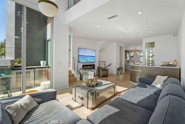 3306 Via Oporto, Newport Beach, CA 92663 - living area with wood finished floors, a chandelier, stairs, and recessed lighting