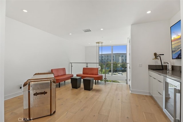 3306 Via Oporto, Newport Beach, CA 92663 - living area featuring beverage cooler, light wood-style flooring, expansive windows, and recessed lighting