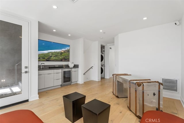 3306 Via Oporto, Newport Beach, CA 92663 - living area with stacked washer / dryer, beverage cooler, light wood finished floors, and recessed lighting