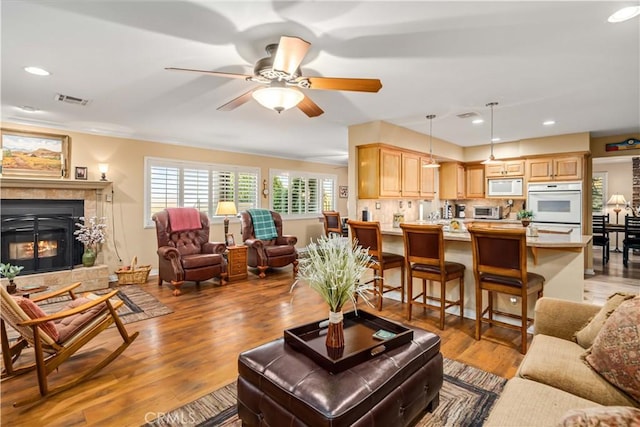35870 Tierra Subida Ave, Palmdale, CA 93551 - living room with a ceiling fan, light wood-style flooring, recessed lighting, and a glass covered fireplace