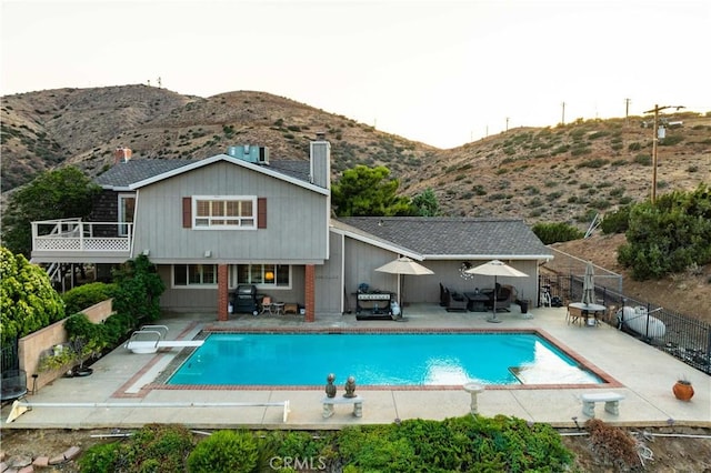 35870 Tierra Subida Ave, Palmdale, CA 93551 - view of pool with a diving board, a mountain view, a patio area, grilling area, and an outdoor living space