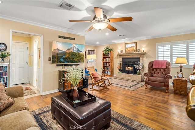 35870 Tierra Subida Ave, Palmdale, CA 93551 - living area featuring a tile fireplace, wood finished floors, ornamental molding, ceiling fan, and recessed lighting