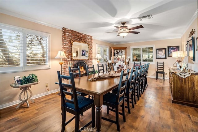 35870 Tierra Subida Ave, Palmdale, CA 93551 - dining area featuring a ceiling fan, wood finished floors, crown molding, and a fireplace