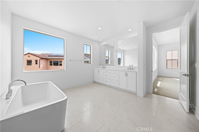 312 Brimwood, Irvine, CA 92618 - bathroom with double vanity, a freestanding bath, recessed lighting, and marble finish flooring