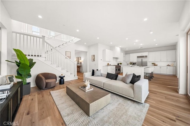 312 Brimwood, Irvine, CA 92618 - living room featuring stairway, light wood-style flooring, and recessed lighting