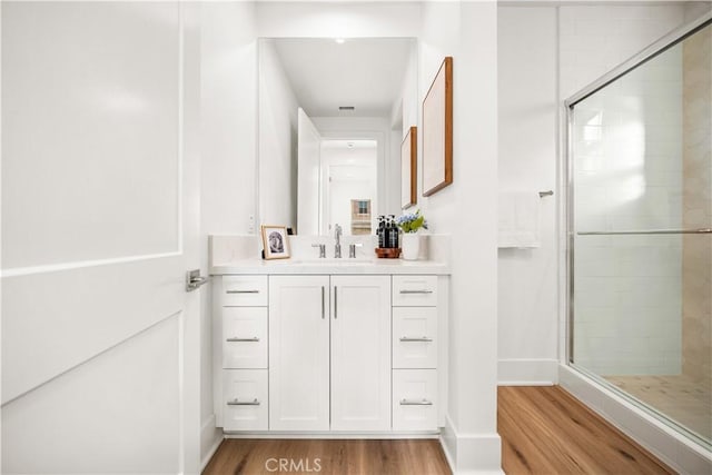 312 Brimwood, Irvine, CA 92618 - bathroom featuring wood finished floors, a stall shower, and vanity