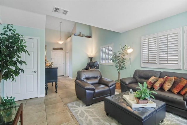 9044 Sylmar Ave, Panorama City, CA 91402 - living room featuring light tile patterned floors and vaulted ceiling