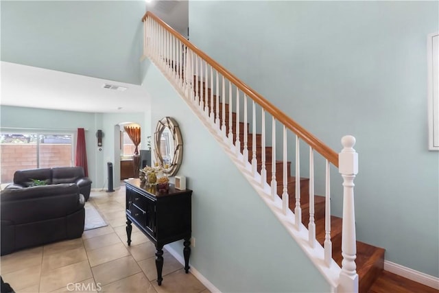 9044 Sylmar Ave, Panorama City, CA 91402 - stairs featuring a high ceiling, tile patterned floors, and arched walkways