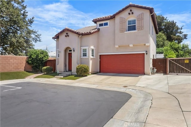 9044 Sylmar Ave, Panorama City, CA 91402 - mediterranean / spanish-style home with stucco siding, a tiled roof, an attached garage, and concrete driveway