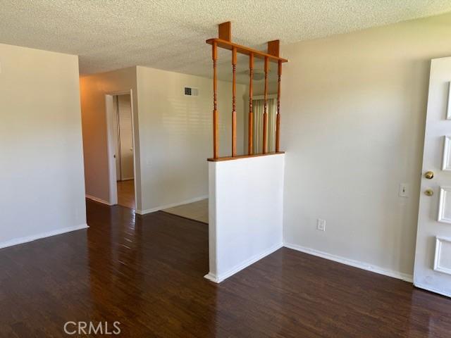 1353 E Fairgrove Ave Unit 293, West Covina, CA 91792 - empty room with wood finished floors and a textured ceiling