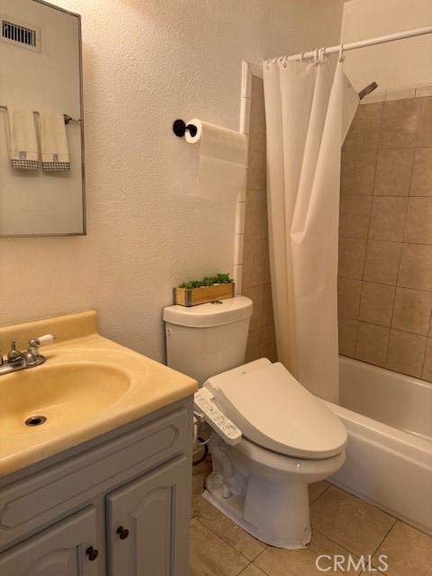 1353 E Fairgrove Ave Unit 293, West Covina, CA 91792 - bathroom featuring vanity, tile patterned floors, and shower / bath combination with curtain