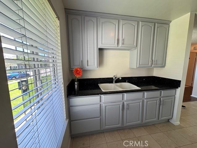1353 E Fairgrove Ave Unit 293, West Covina, CA 91792 - kitchen featuring dark countertops and light tile patterned floors