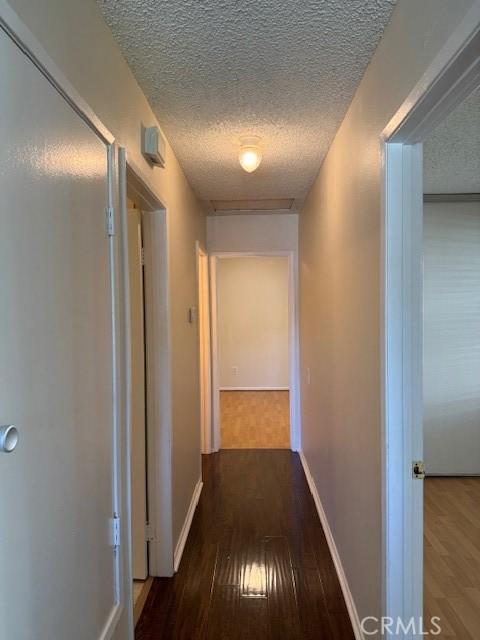 1353 E Fairgrove Ave Unit 293, West Covina, CA 91792 - hall with hardwood / wood-style flooring and a textured ceiling