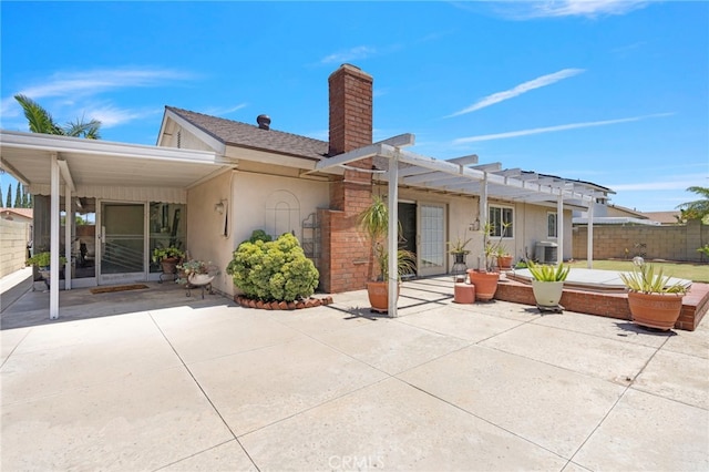 3186 N Hartman St, Orange, CA 92865 - back of property with a chimney, a patio area, stucco siding, a pergola, and a shingled roof