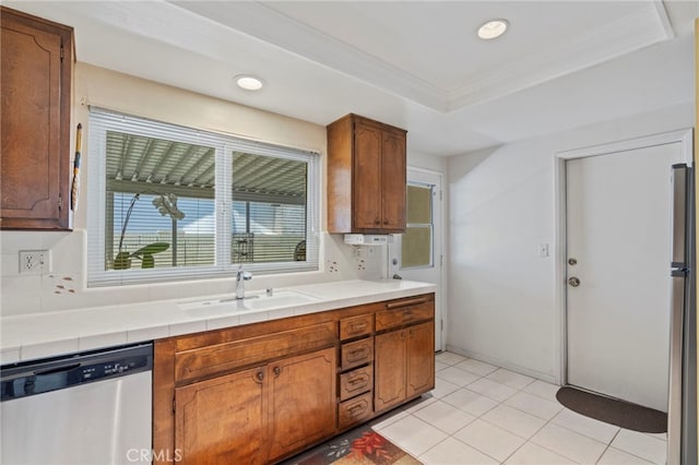 3186 N Hartman St, Orange, CA 92865 - kitchen with stainless steel appliances, a tray ceiling, brown cabinetry, tile counters, and recessed lighting