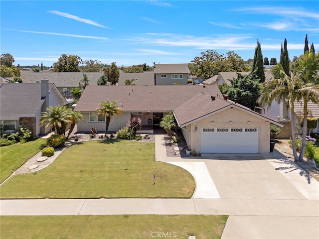 3186 N Hartman St, Orange, CA 92865 - view of front of house featuring a garage, driveway, a residential view, and a front yard