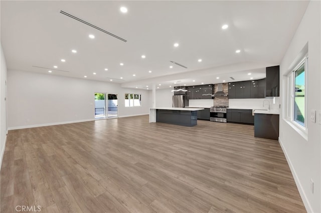 14625 Runnymede St, Van Nuys, CA 91405 - unfurnished living room with recessed lighting, light wood-style flooring, and lofted ceiling