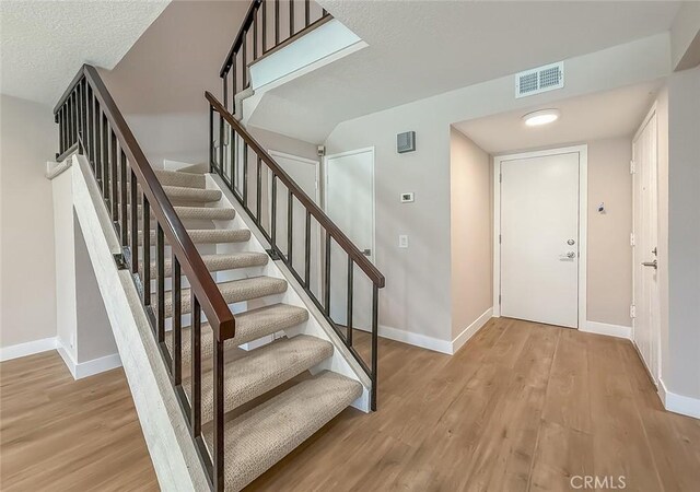 19237 Index St Unit 5, Porter Ranch, CA 91326 - foyer entrance featuring wood finished floors and stairway