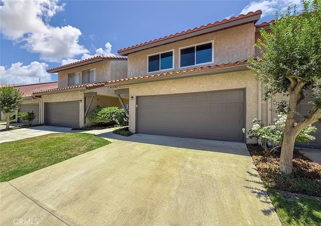 19237 Index St Unit 5, Porter Ranch, CA 91326 - view of front facade featuring driveway, stucco siding, and a tile roof