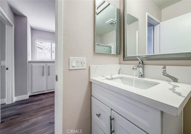 19237 Index St Unit 5, Porter Ranch, CA 91326 - bathroom featuring wood finished floors, vanity, and a textured wall