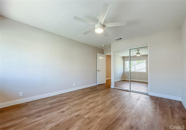 19237 Index St Unit 5, Porter Ranch, CA 91326 - unfurnished bedroom featuring a closet, wood finished floors, ceiling fan, and a textured ceiling