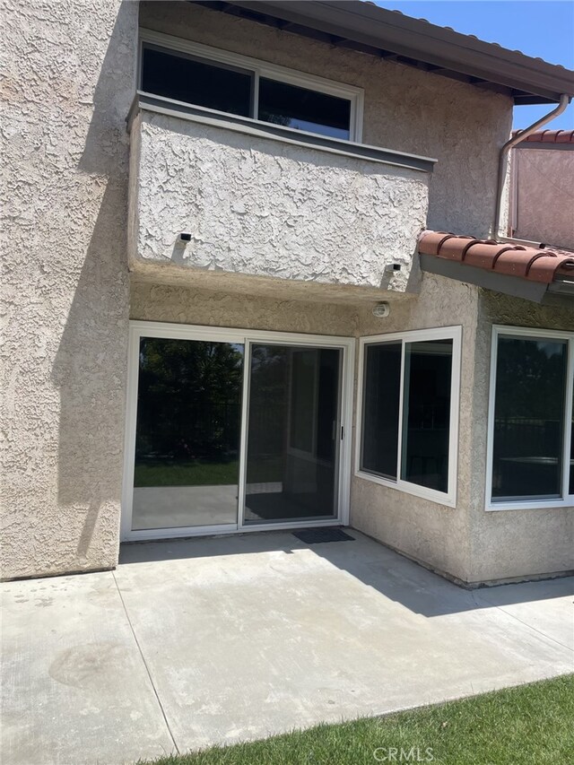 19237 Index St Unit 5, Porter Ranch, CA 91326 - rear view of house with stucco siding and a patio area