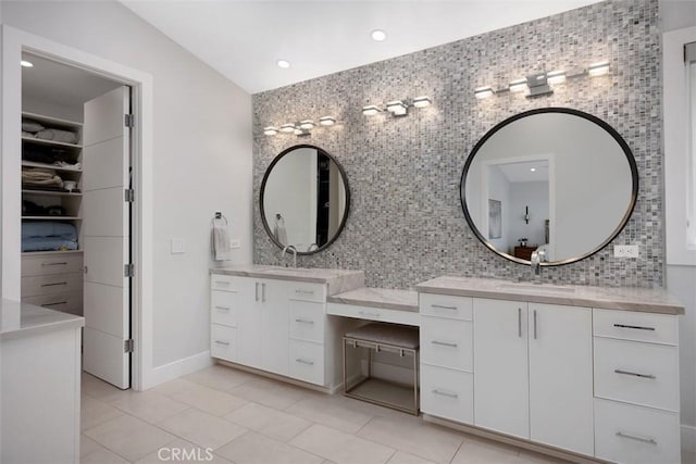 27705 Homestead Rd, Laguna Niguel, CA 92677 - bathroom with tile patterned flooring, vanity, tasteful backsplash, a walk in closet, and tile walls