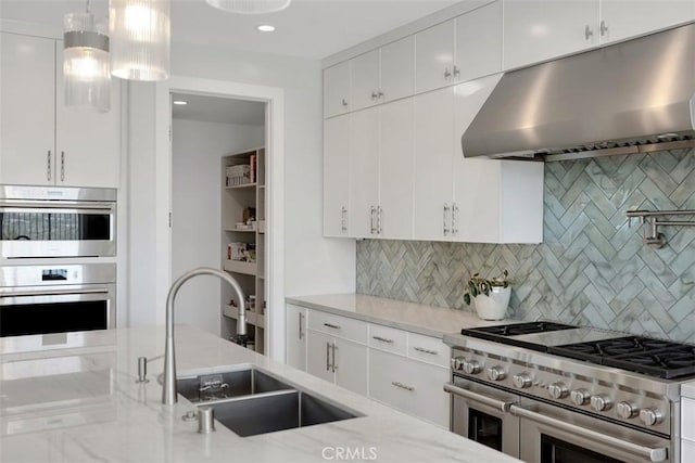 27705 Homestead Rd, Laguna Niguel, CA 92677 - kitchen featuring exhaust hood, appliances with stainless steel finishes, light stone counters, backsplash, and recessed lighting